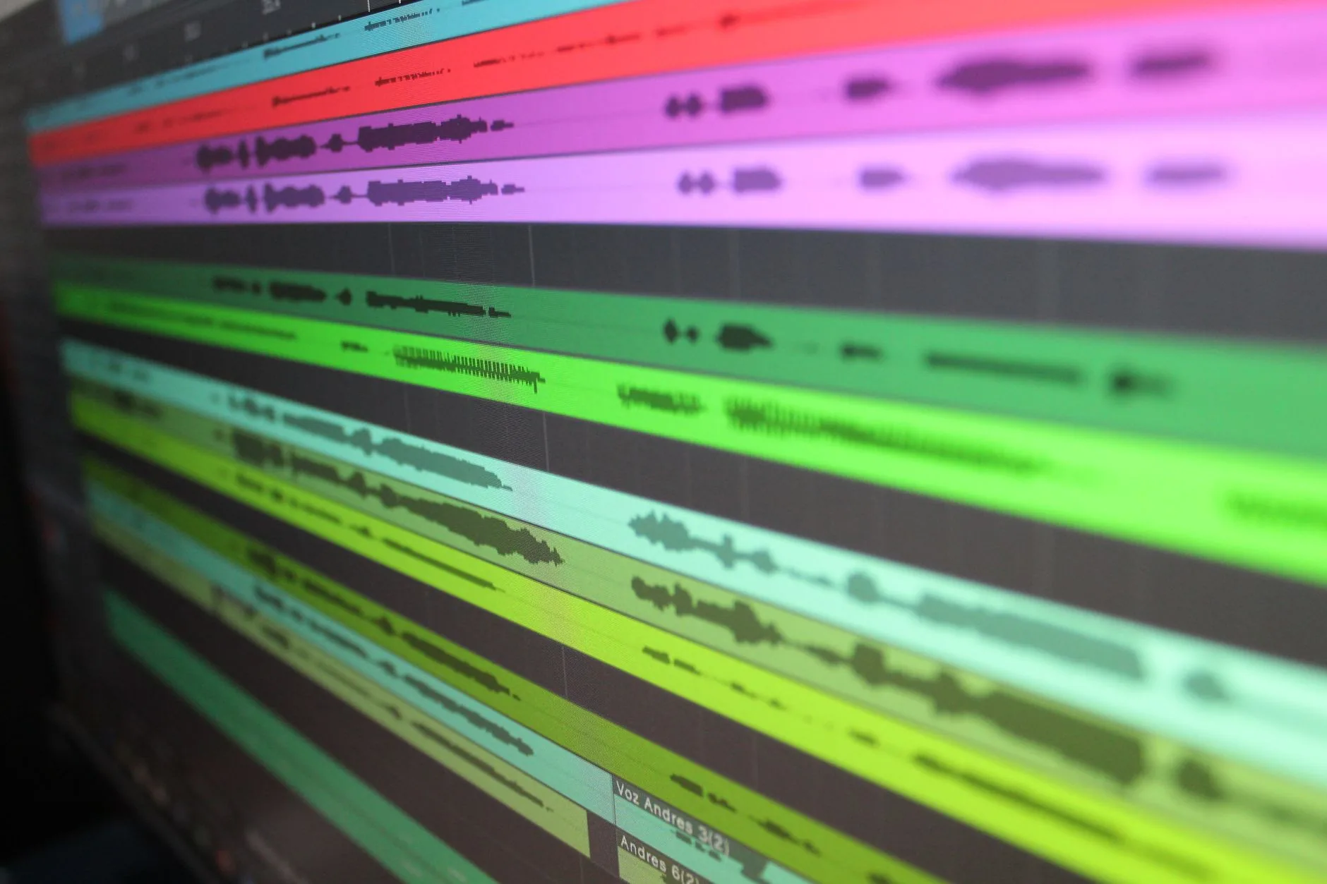 Audio engineer in dimly lit studio, monitoring equipment for 1 kHz tone testing.