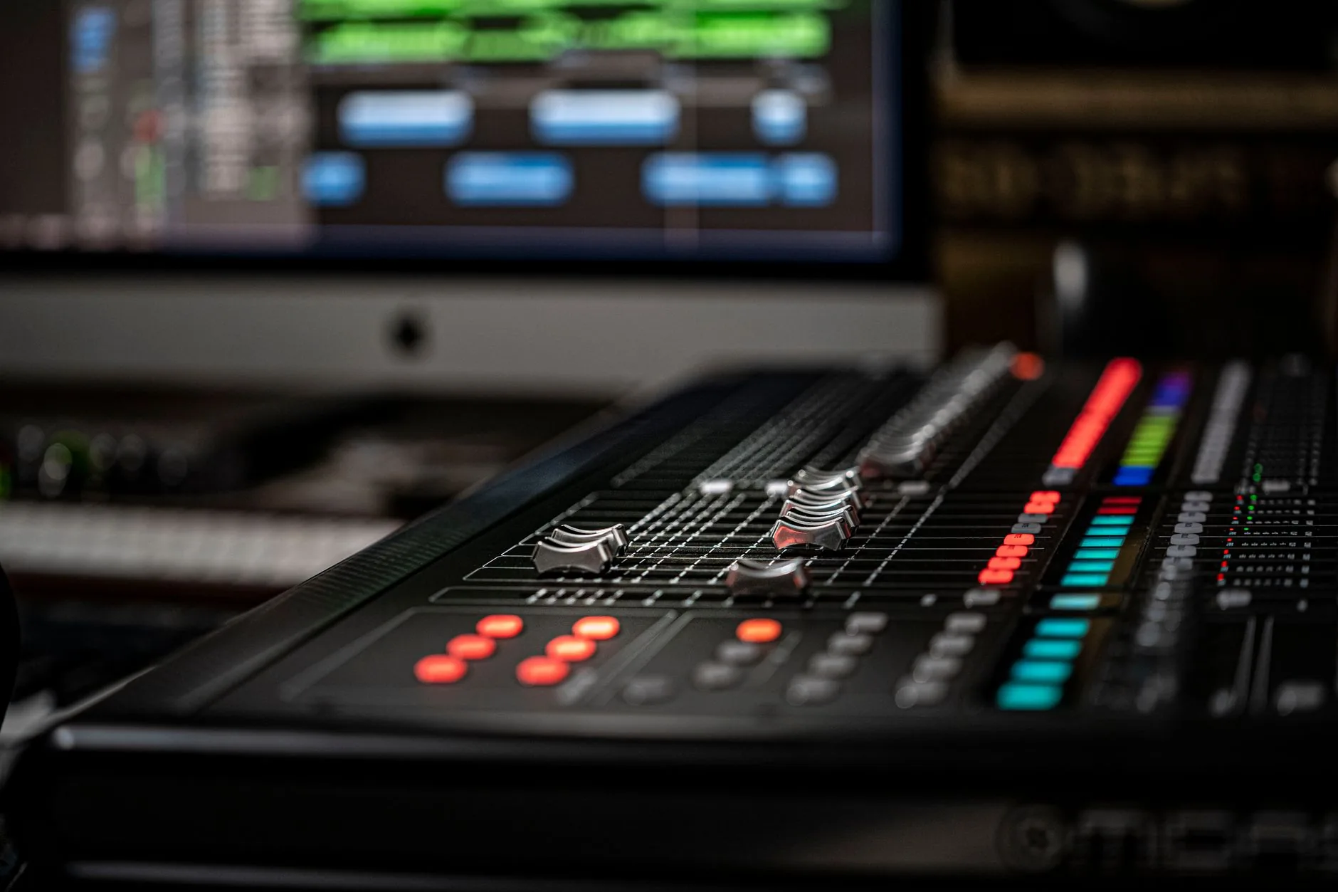 Sound engineer tweaking knobs in dimly lit audio studio, high-frequency audio applications.
